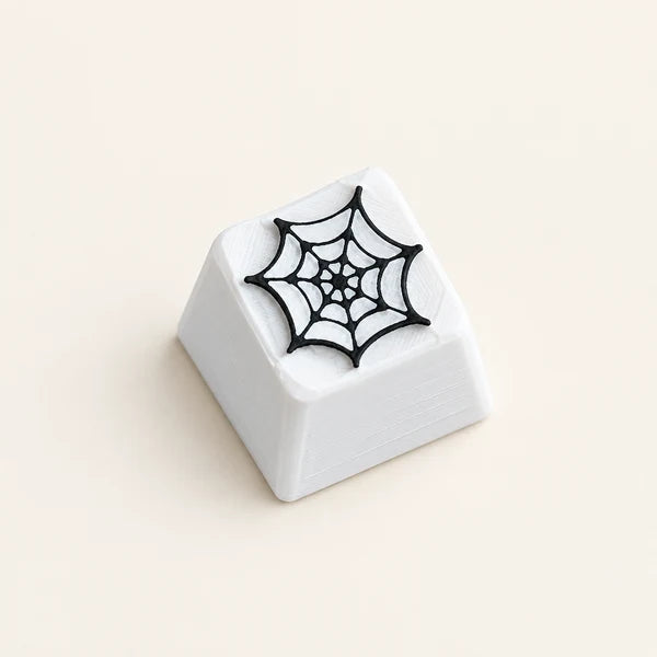 Een witte keycap met een spinnenweb voor je clicker of toetsenbord